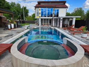 a swimming pool in front of a house at vila darkoni in Bijeljina +48 photos