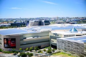 an overhead view of a building with a city in the background at SoftStay Ellipse Luxury Apartment in Midrand +2 photos