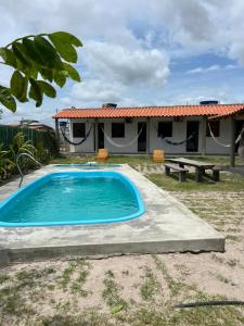 a pool in front of a house at Suíte Adam 2 em Caraíva com Piscina 900m da Vila in Caraíva