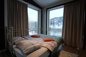 a bedroom with a bed and a large window at Креси in Yaremche +58 photos