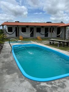 a pool in front of a house at Suíte Adam 2 em Caraíva com Piscina 900m da Vila in Caraíva