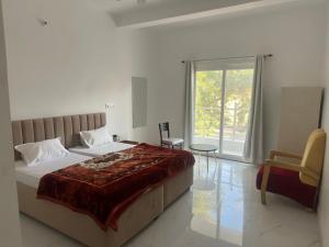 a bedroom with a large bed and a window at Shri radha kripalu dham in Vrindāvan