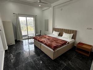 a bedroom with a large bed and a large window at Shri radha kripalu dham in Vrindāvan