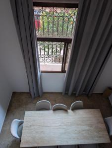 a table and chairs in a room with a window at Gueliz Appartement in Marrakesh +14 photos