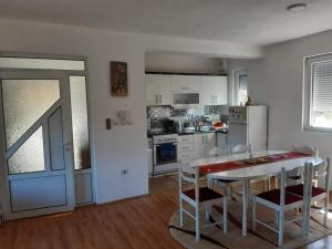a kitchen with a table and chairs and a dining room at Villa Elena in Čiflik