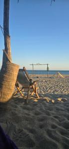 a beach with a hammock and a volleyball net at Casa Laud Cuarto Guamuchil in Guayabas
