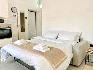 a bedroom with a large bed with towels on it at Corso 42 in Novara