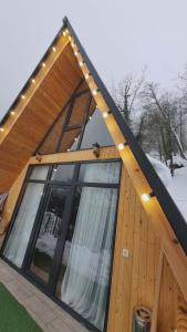 a house with a gambrel roof with a window at Mountain Hearth in Zeda Ch'khutunet'i