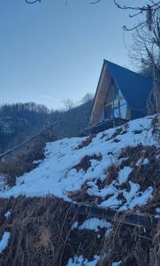 a house on the side of a hill with snow at Mountain Hearth in Zeda Ch'khutunet'i +4 photos