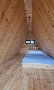 a bedroom with a large bed in a wooden ceiling at Mountain Hearth in Zeda Ch'khutunet'i
