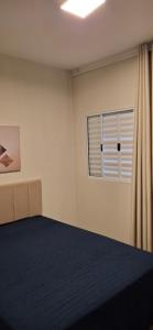 a bedroom with a bed and a window at Vieira's Residencial in Embu
