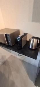 a box and a tea kettle on a table at Vieira's Residencial in Embu