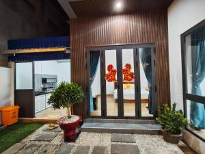 a room with sliding glass doors with a view of a bedroom at Sơn Hà homestay in Ấp Bình Hưng
