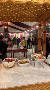 a buffet line with two bowls of food on a table at Ayla Rum Luxury Camp in Wadi Rum