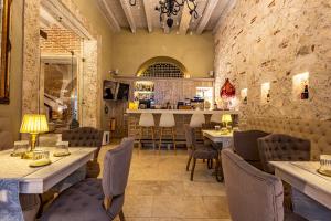 a restaurant with tables and chairs and a bar at Hotel Casa del Gobernador in Cartagena de Indias
