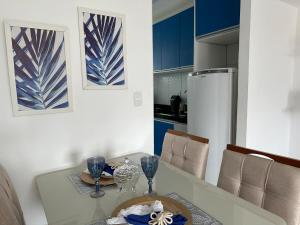 a kitchen with a table with wine glasses on it at Refúgio Azul Vog Ville Sul in Caruaru