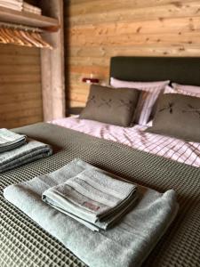 a bed with folded blankets and towels on it at Neds Barn in Galway