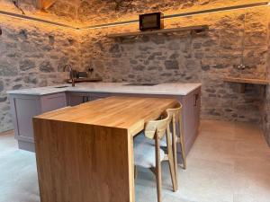 a kitchen with a wooden table and a sink at Neds Barn in Galway