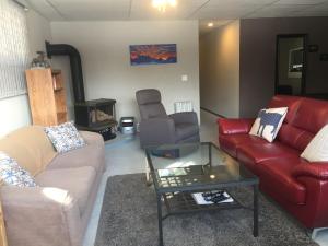 a living room with two couches and a coffee table at Bed & Breakfast Monarch in Canmore