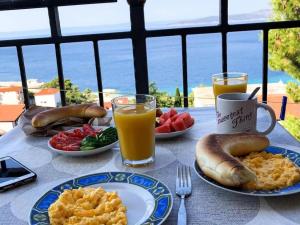 a table with plates of breakfast food and drinks at Studio Apartments Ivo in Baška Voda +34 photos
