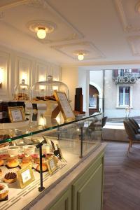 a bakery with a display case with pastries on it at Zogbi Hospitality Aubonne 3 in Aubonne