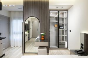 a living room with a mirror and a table at Flexistay Sheikh Zayed in Sheikh Zayed