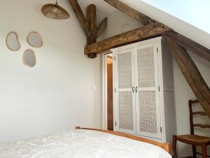 a bedroom with a white bed and a window at La Maison Agoméa in Saint-Georges-sur-Cher +17 photos