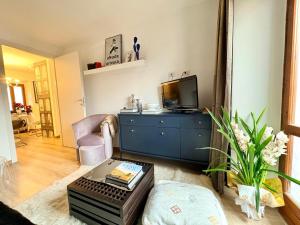 a living room with a blue dresser and a tv at Maison Lake Maggiore Art Stay,central Baveno, 60 mt from Lake and Hotel Dino Congress Center in Baveno