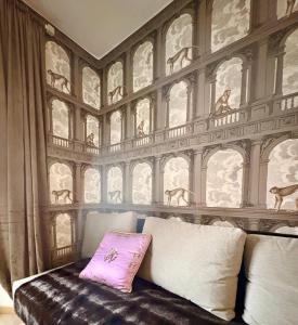 a bedroom with a wall with animals on it at Maison Lake Maggiore Art Stay,central Baveno, 60 mt from Lake and Hotel Dino Congress Center in Baveno