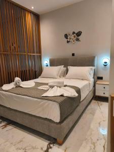 a bedroom with a large bed with white pillows at Castle View Serenity Square in Koroni