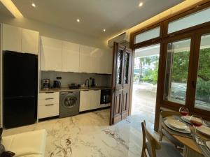 a kitchen with a washer and dryer and a table at Castle View Serenity Square in Koroni