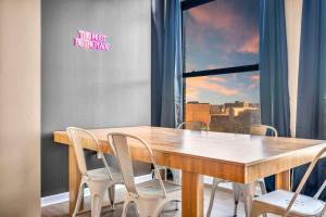 a wooden table and chairs in a room with a window at Fun 2Bed Apt Skeeball Foosball FREE Parking in Cleveland