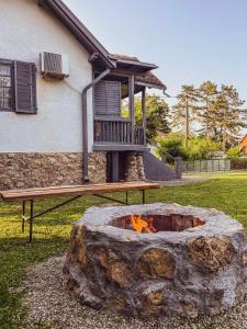 a fire pit in front of a house at Kuća za odmor Banja Koviljača in Banja Koviljača