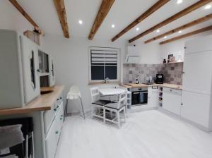 a kitchen with white counters and white appliances at Ferienhaus Marion in Steinhagen