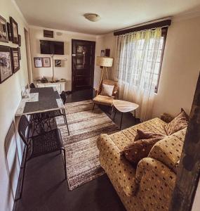 a living room with a couch and a table at Kuća za odmor Banja Koviljača in Banja Koviljača