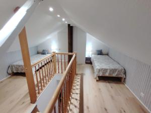 a attic room with two beds and a staircase at Ferienhaus Marion in Steinhagen