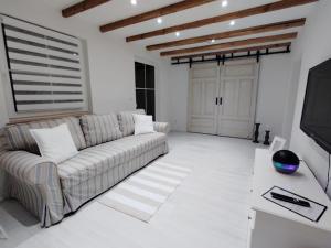 a living room with a couch and a tv at Ferienhaus Marion in Steinhagen