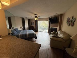 a living room with a couch and a bed at Rivers Edge 803c in Helen