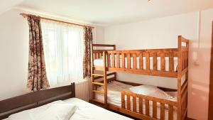 a bedroom with two bunk beds and a window at Cabana Eduard in Rişca
