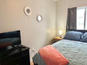 a bedroom with a bed and a clock on the wall at Queen Bed Private Room Shared Living Spaces in Johnson City +6 photos