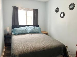 a bedroom with a bed with a window and a bedspread at Private Room-Queen Bed-Shared Living Spaces in Johnson City +6 photos