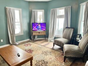 a living room with a tv and two chairs at Private Room-Shared Common Spaces-Queen Bed in Johnson City