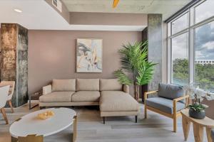 a living room with a couch and a table at Spacious Apartment Masterfully Decorated in Orlando