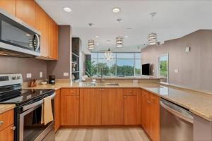 a large kitchen with wooden cabinets and stainless steel appliances at Spacious Apartment Masterfully Decorated in Orlando