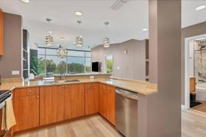 a kitchen with wooden cabinets and stainless steel appliances at Spacious Apartment Masterfully Decorated in Orlando