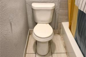 a toilet in the corner of a bathroom at Mi Amor Inn & Suites by Hotel O Dallas Tx Hwy 352 in Dallas