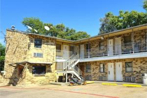 a brick building with a staircase in a parking lot at Mi Amor Inn & Suites by Hotel O Dallas Tx Hwy 352 in Dallas