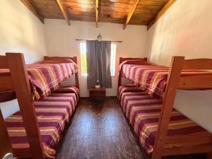 two bunk beds in a room with a window at Complejo Samaya in San Clemente del Tuyú +2 photos