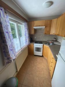 a small kitchen with a stove and a window at Chata v Poustce in Benecko
