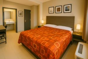 a hotel room with a bed and a bathroom at Hotel Fuego Bronx near Yankee Stadium in Bronx